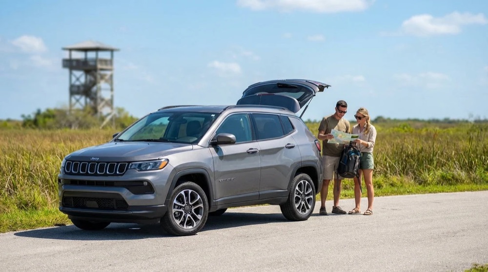 Couple checking a map beside their SUV on a Florida road